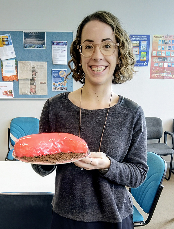 Woman holding a Giant Pink Slug cake