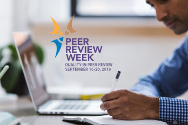 Soft focus photo of man writing with laptop, with Peer Review Week logo appearing over top