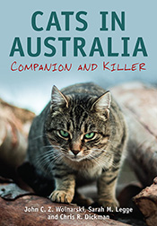 Cover of Cats in Australia featuring a crouching green-eyed cat glaring directly at the viewer.