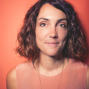 Head shot of illustrator Rachel Tribout against an orange background