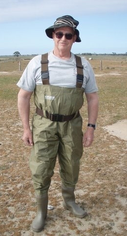 Günther Theischinger standing in an open field, dressed in gumboots and a khaki-coloured wading suit.