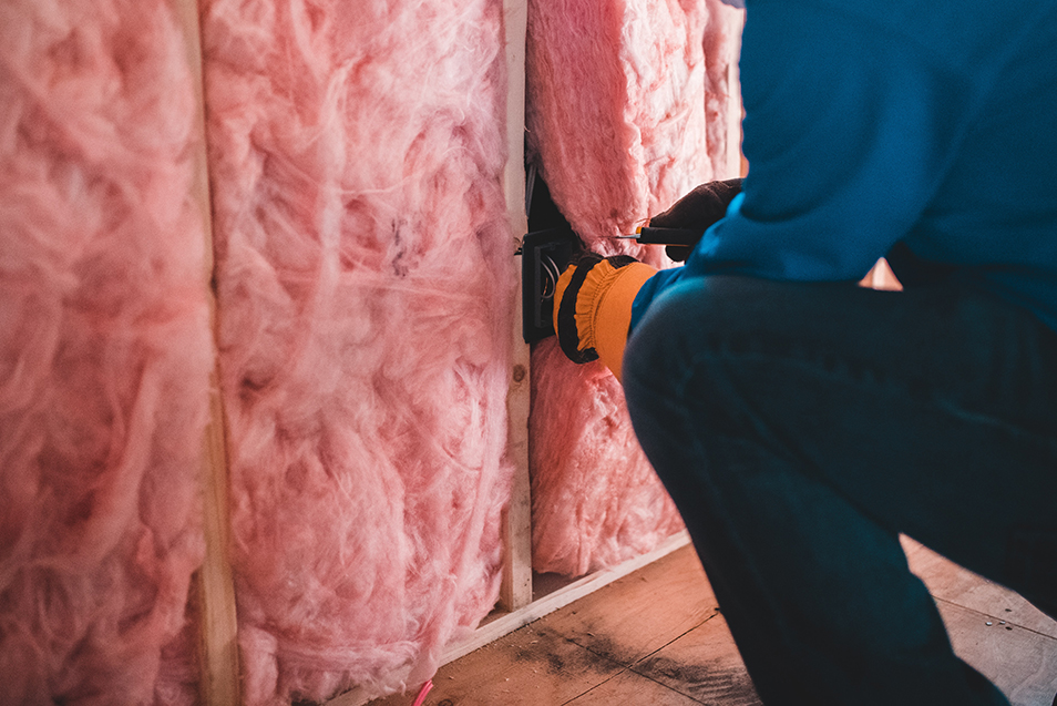 Pink insulation being installed