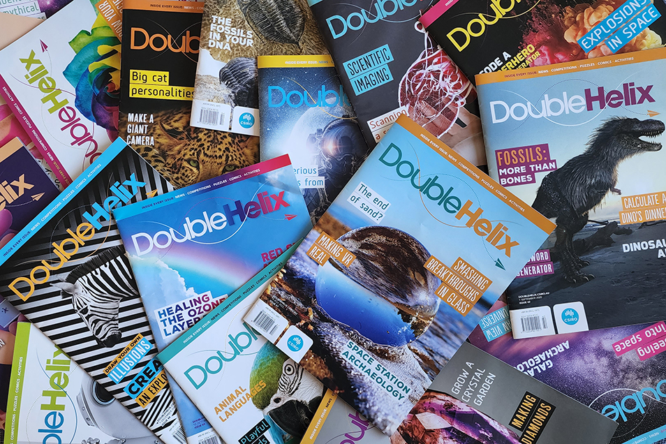 A pile of Double Helix magazines with a wide variety of cover subjects